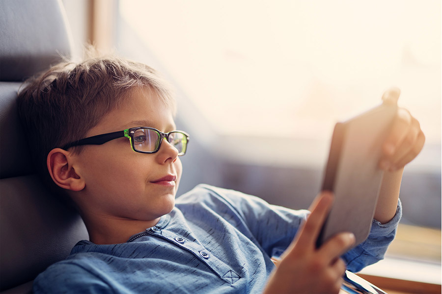 child with glasses on computer